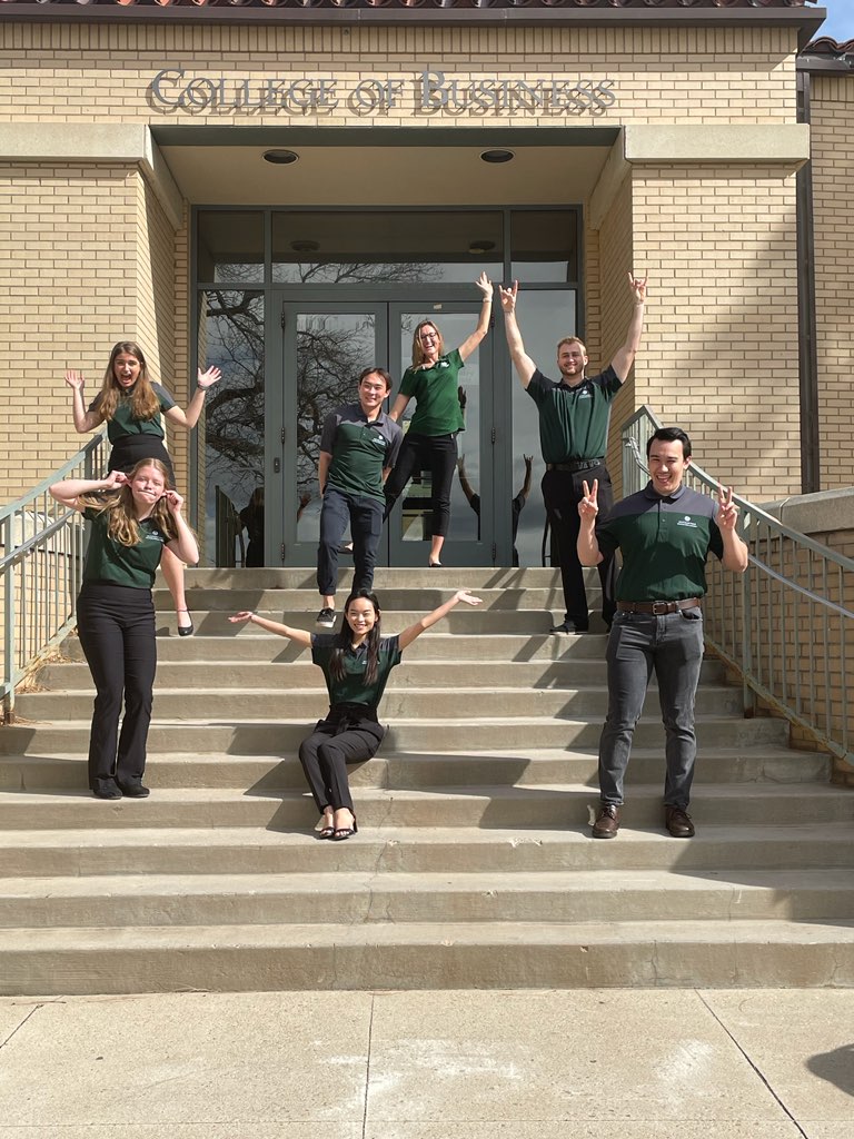 Campus Challenge team poses for a silly photo on the front steps of the College of Business