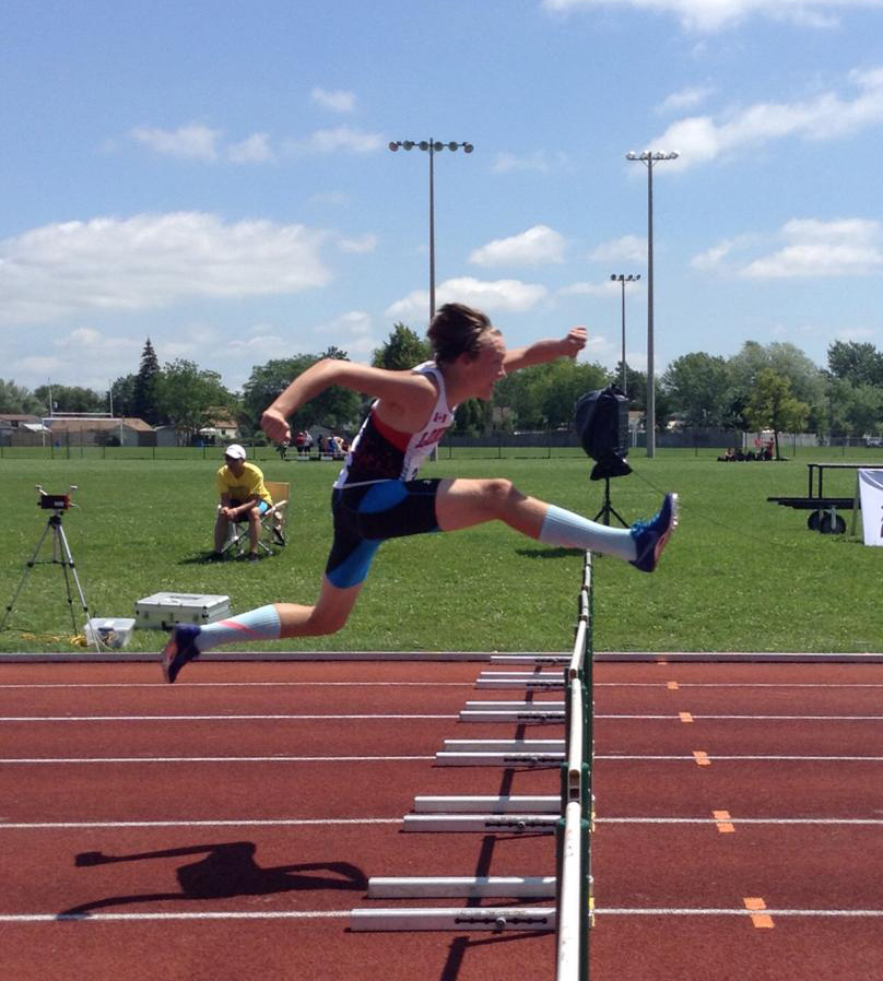 Liam Mather jumping over hurdle