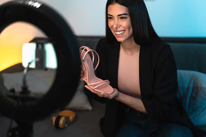 An influencer speaks to her audience about shoes