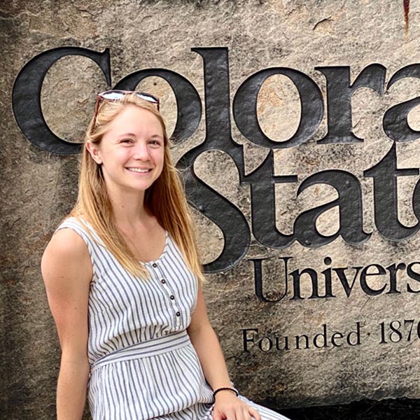 Addie Arnold in front of the CSU sign on campus.