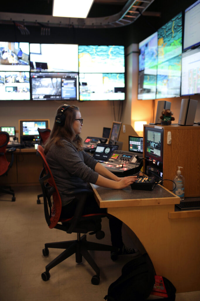 A member of the College of Business' video team works in the video production room