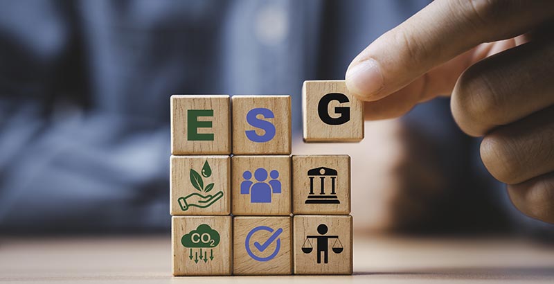 A businessman assembles an ESG strategy out of blocks.